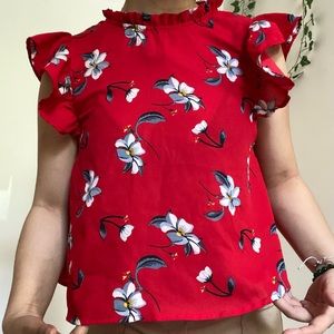 Red with white and blue flowers. Ruffled shoulders. Sleeveless.